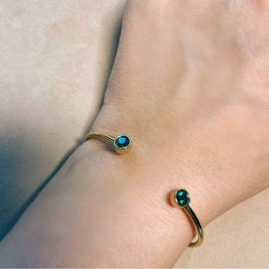 Gold Bracelet with green gemstone.